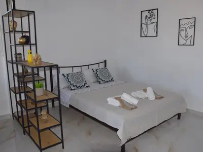 a bedroom with a bed with towels on it at Gemini Apartment in Afantou