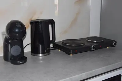 a counter top with a coffee maker and a blender at Gemini Apartment in Afantou