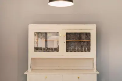 a white cabinet with glass doors in a room at Quattro Zie in Rhodes Town
