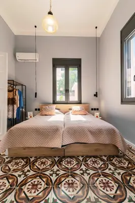 a bedroom with a large bed and a rug at Quattro Zie in Rhodes Town
