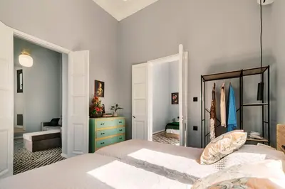 a bedroom with a bed and a blue dresser at Quattro Zie in Rhodes Town