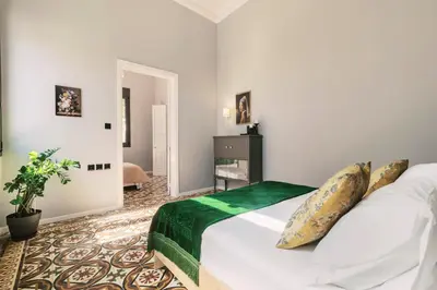 a bedroom with a large white bed in a room at Quattro Zie in Rhodes Town