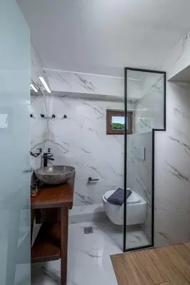 a bathroom with a sink and a toilet and a mirror at Elia Suites - Old Town in Rhodes Town