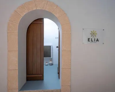 an archway with a wooden door in a room at Elia Suites - Old Town in Rhodes Town