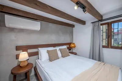 a bedroom with a white bed and a window at Elia Suites - Old Town in Rhodes Town