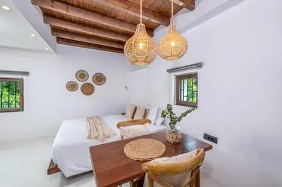 a bedroom with a bed and a table and chairs at Elia Suites - Old Town in Rhodes Town