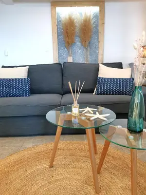 a living room with a couch and a glass table at Alexandra's Sea Front Villa in Pefki Rhodes