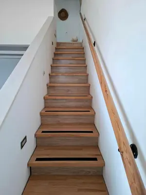 a staircase in a house with wooden floors at Alexandra's Sea Front Villa in Pefki Rhodes