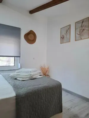a bedroom with a bed with towels on it at Alexandra's Sea Front Villa in Pefki Rhodes