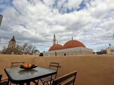 a bowl of fruit on a table on a balcony at Tiny Clock House in Rhodes Town