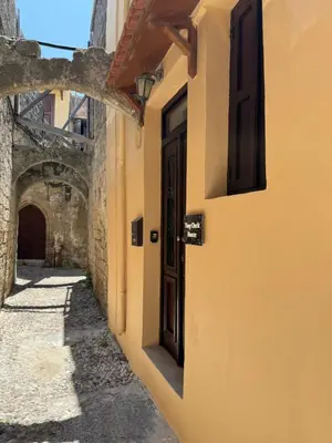 an alley with an open door in a building at Tiny Clock House in Rhodes Town