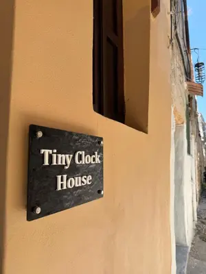 a sign on the side of a tiny closet house at Tiny Clock House in Rhodes Town