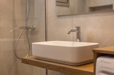 a white sink in a bathroom with a shower at Villa Pava-sea view brand new villa in Archangelos