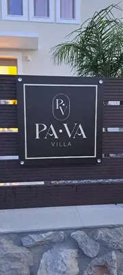 a sign on a bench in front of a building at Villa Pava-sea view brand new villa in Archangelos
