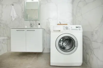 a white washing machine in a bathroom with a sink at Gio Center Apartment in Rhodes Town