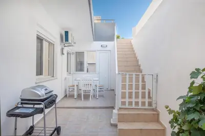 a patio with stairs and a grill in front of a house at Gio Center Apartment in Rhodes Town