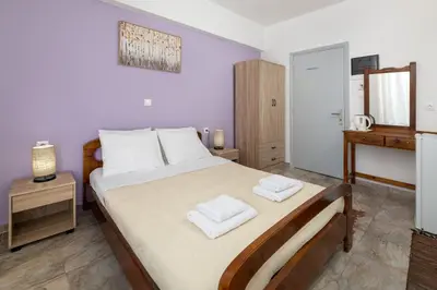 a bedroom with a bed with two towels on it at Amethyst Rooms in Rhodes Town