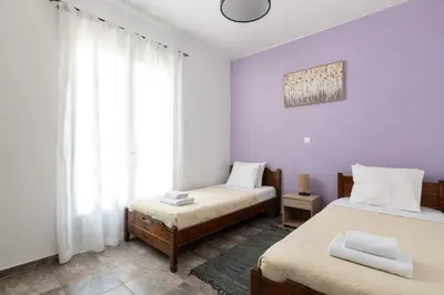 a bedroom with two beds and a window at Amethyst Rooms in Rhodes Town