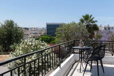 a balcony with a table and chairs on a balcony at Amethyst Rooms in Rhodes Town