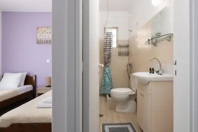 a small bathroom with a toilet and a sink at Amethyst Rooms in Rhodes Town