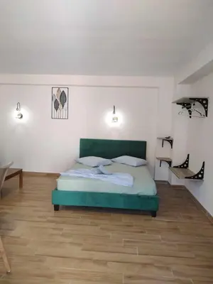 a bedroom with a green bed in a room at Stergios Suite with Private Jacuzzi in Kolimbia