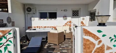 a living room with a couch and a table at Stergios Suite with Private Jacuzzi in Kolimbia