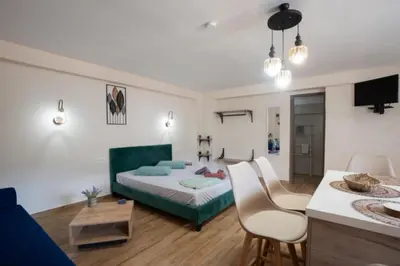 a bedroom with a bed and a table and chairs at Stergios Suite with Private Jacuzzi in Kolimbia