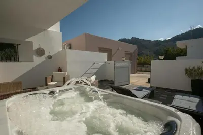 a bath tub with water in it on a patio at Stergios Suite with Private Jacuzzi in Kolimbia