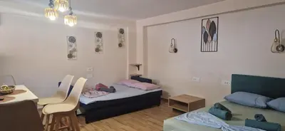 a small room with a bed and a table and a desk at Stergios Suite with Private Jacuzzi in Kolimbia