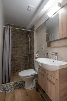 a bathroom with a toilet and a sink and a shower at Stergios Suite with Private Jacuzzi in Kolimbia