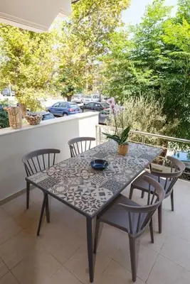 a table and chairs sitting on a balcony with a table and chairs at J&G Rhodes city flat in Rhodes Town