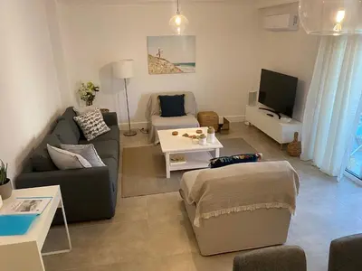 a living room with a couch and a tv at New Best Priced Walkable Beach Sites City Rhodes Town Apartment in Rhodes Town
