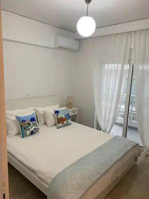 a bedroom with a large white bed with pillows at New Best Priced Walkable Beach Sites City Rhodes Town Apartment in Rhodes Town