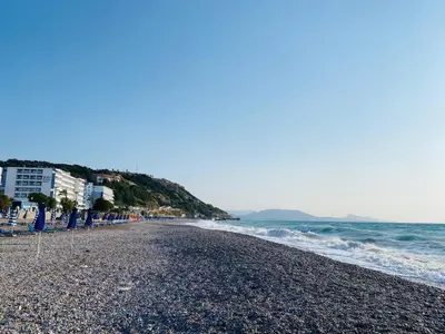 a beach with a rocky shoreline and the ocean at New Best Priced Walkable Beach Sites City Rhodes Town Apartment in Rhodes Town