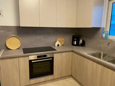 a kitchen with white cabinets and a stove and a sink at New Best Priced Walkable Beach Sites City Rhodes Town Apartment in Rhodes Town