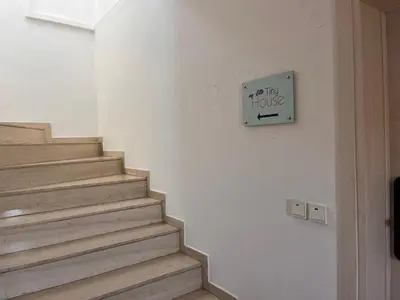 a staircase with a sign that reads off the house at My Little Tiny House in Rhodes Town