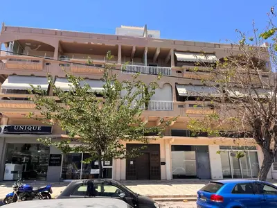 a building with cars parked in front of it at My Little Tiny House in Rhodes Town