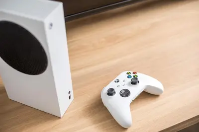 a video game controller sitting next to a speaker at My Little Tiny House in Rhodes Town