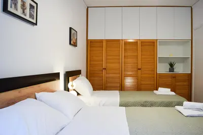 a bedroom with two beds and a closet at My Green Eden in Rhodes in Ialyssos