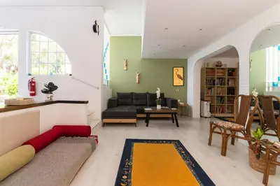 a living room with a couch and a table at My Green Eden in Rhodes in Ialyssos