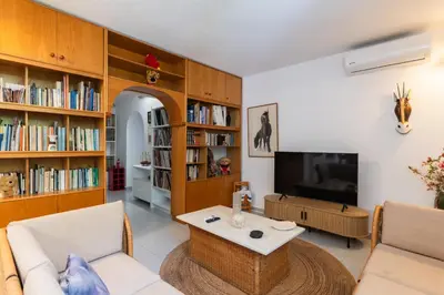 a living room with a couch and a tv at My Green Eden in Rhodes in Ialyssos