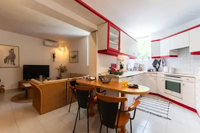 a kitchen with a table and a dining room at My Green Eden in Rhodes in Ialyssos