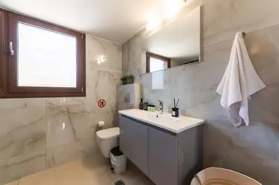 a white bathroom with a sink and a toilet at My Green Eden in Rhodes in Ialyssos