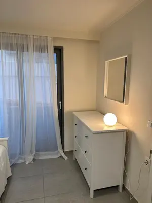 a bedroom with a dresser and a mirror and a window at Melita Downtown Seaview in Rhodes Town