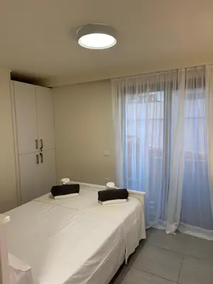 a bedroom with a large white bed and a window at Melita Downtown Seaview in Rhodes Town