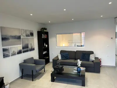 a living room with a couch and a chair at Melita Downtown Seaview in Rhodes Town