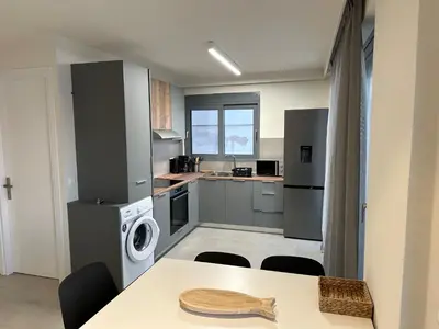 a kitchen with a table and a washer at Melita Downtown Seaview in Rhodes Town