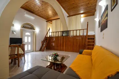 a living room with a couch and a table at Sofia Traditional House in Afantou