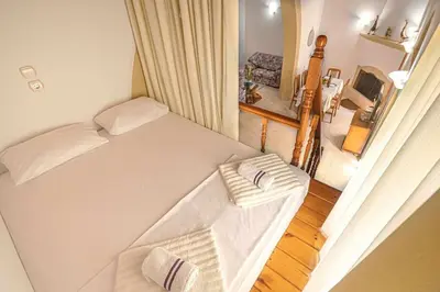 a bedroom with a bed with two towels on it at Sofia Traditional House in Afantou