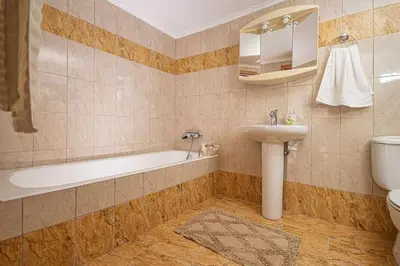 a bathroom with a tub and a sink and a toilet at Sofia Traditional House in Afantou